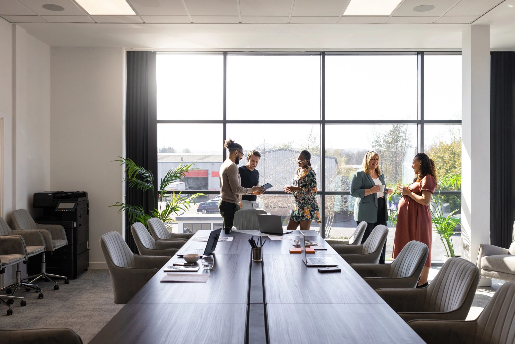 Colleagues discussing plans in a modern office